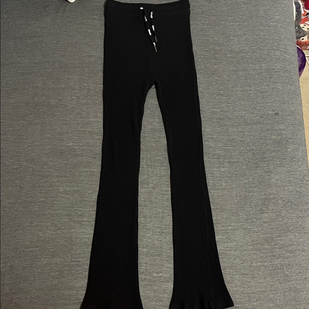 High-waisted Black ribbed Flared Women's Leggings with matching crop tank top.